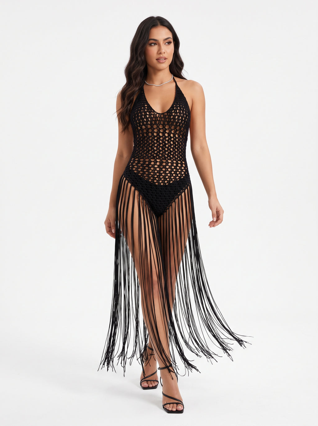 Model wearing a black crochet halter maxi dress with floor-length fringe over a black bodysuit